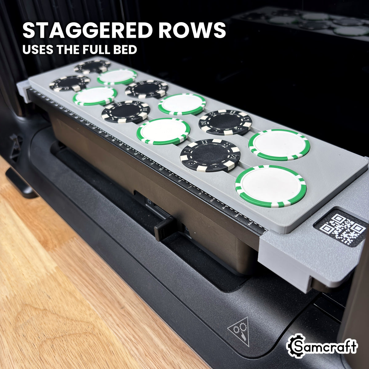 Angled view of the Samcraft eufyMake E1 poker chip jig showing its two staggered rows of chips running the full length of the print bed.