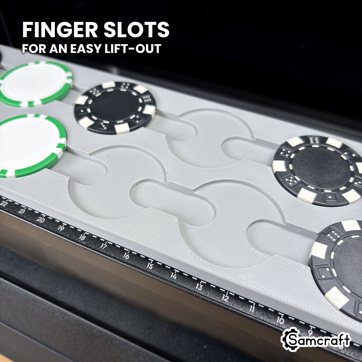Close-up of the Samcraft eufyMake E1 poker chip jig with two pockets empty, showing the finger slots between the pockets for lifting chips out.