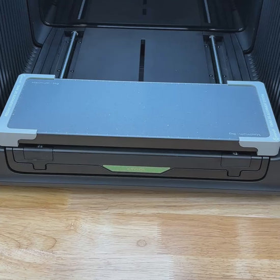 Video of the Samcraft car coaster jig for the xTool Omni UV printer being loaded with coasters and placed on the printer bed.