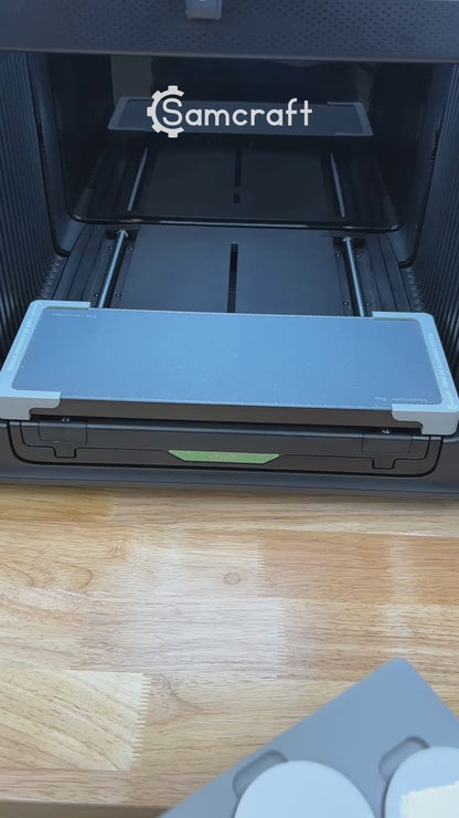 Video of the Samcraft car coaster jig for the xTool Omni UV printer being loaded with coasters and placed on the printer bed.