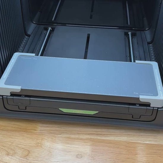 Video of the Samcraft round wooden bottle opener jig for the xTool Omni UV printer being loaded with openers and placed on the printer bed.