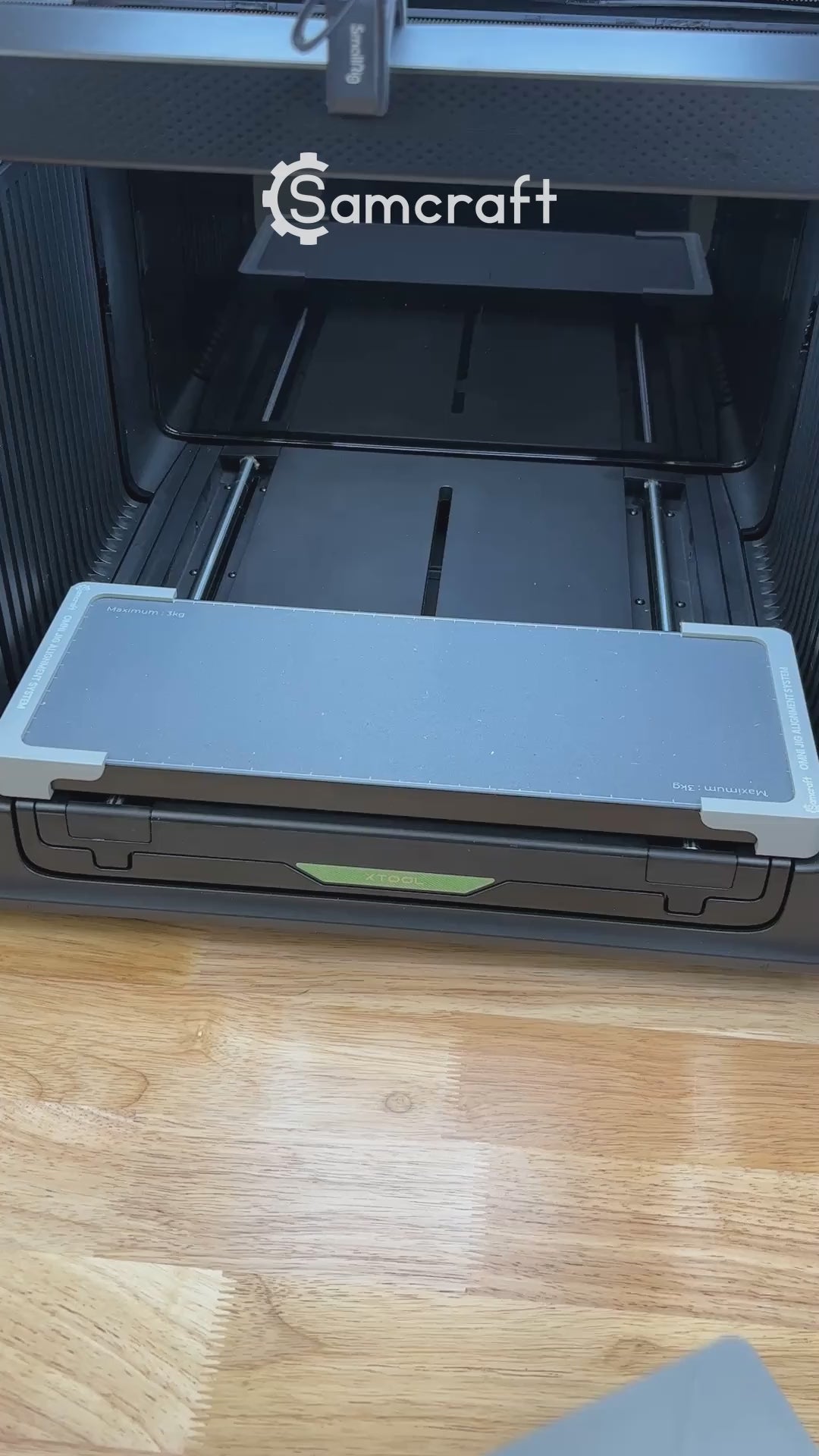 Video of the Samcraft round wooden bottle opener jig for the xTool Omni UV printer being loaded with openers and placed on the printer bed.