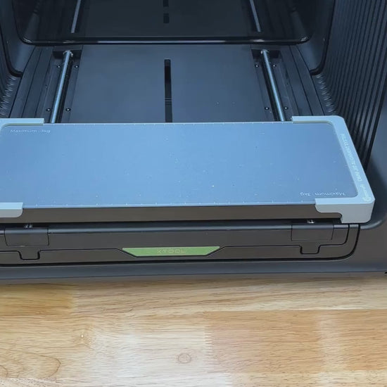 Video of the Samcraft bottle stopper jig for the xTool Omni UV printer being loaded with wooden bottle stoppers and placed on the printer bed.