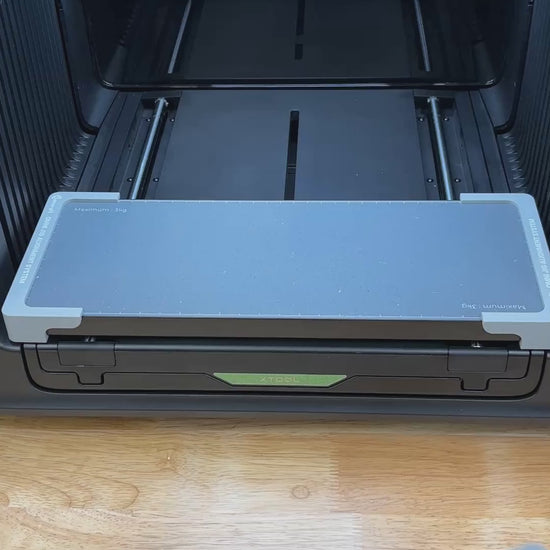 Video of the Samcraft flip top lighter jig for the xTool Omni UV printer being loaded with lighters and placed on the printer bed.
