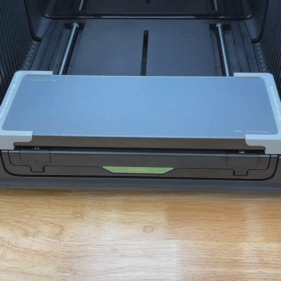 Video of the Samcraft golf ball jig for the xTool Omni UV printer being loaded and placed on the printer bed.