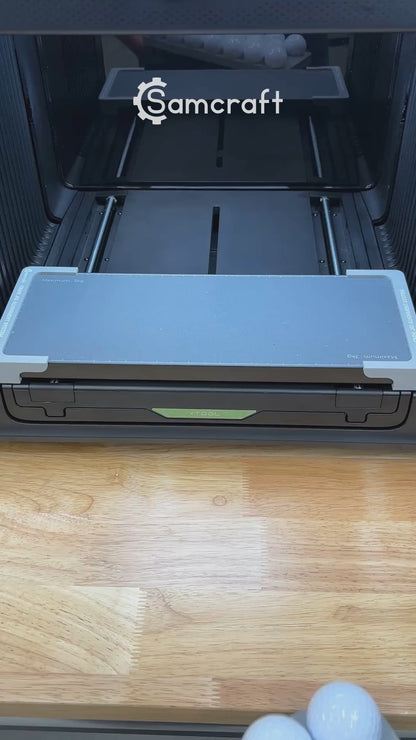 Video of the Samcraft golf ball jig for the xTool Omni UV printer being loaded and placed on the printer bed.