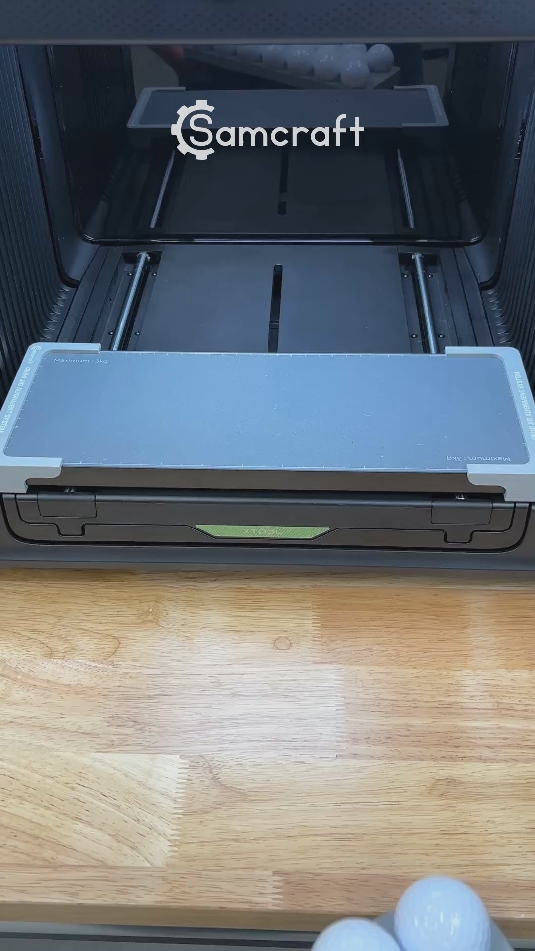 Video of the Samcraft golf ball jig for the xTool Omni UV printer being loaded and placed on the printer bed.