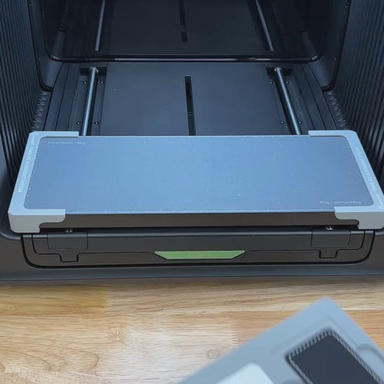 Video of the Samcraft rectangle patch jig for the xTool Omni UV printer being loaded with leatherette patches and placed on the printer bed.
