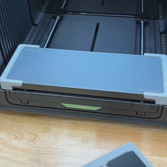 Video of the Samcraft metal wallet jig for the xTool Omni UV printer being loaded with card holder wallets and placed on the printer bed.