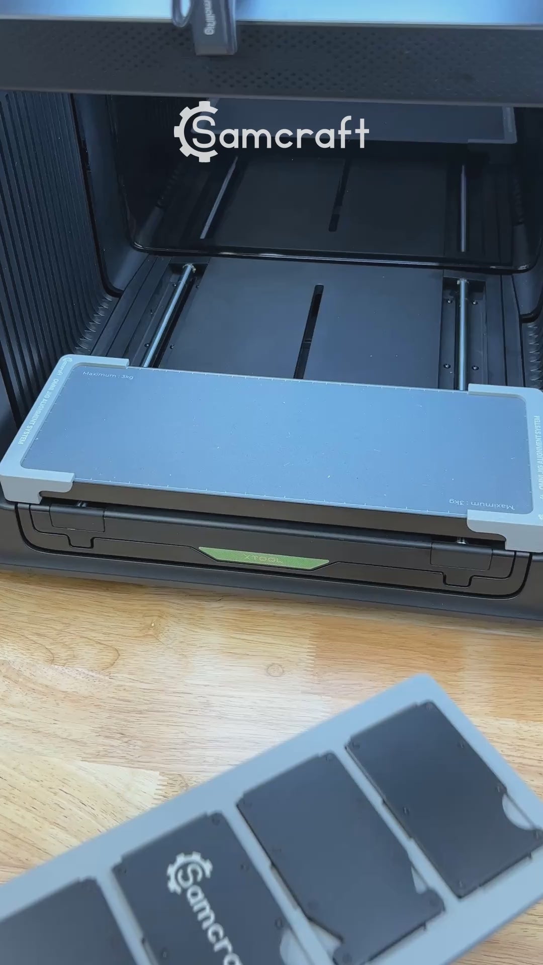 Video of the Samcraft metal wallet jig for the xTool Omni UV printer being loaded with card holder wallets and placed on the printer bed.