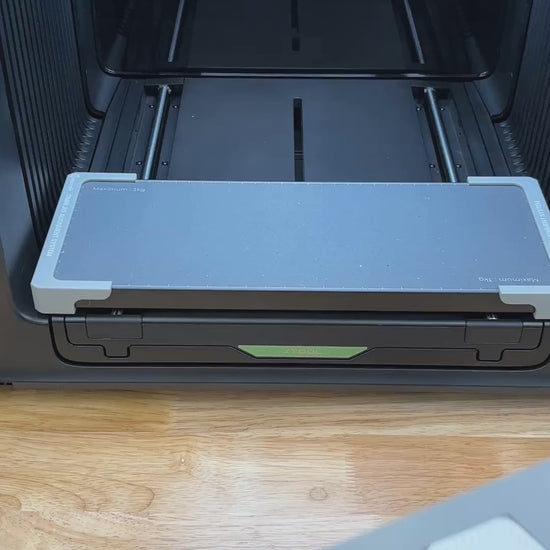 Video of the Samcraft hex patch jig for the xTool Omni UV printer being loaded with leatherette patches and placed on the printer bed.