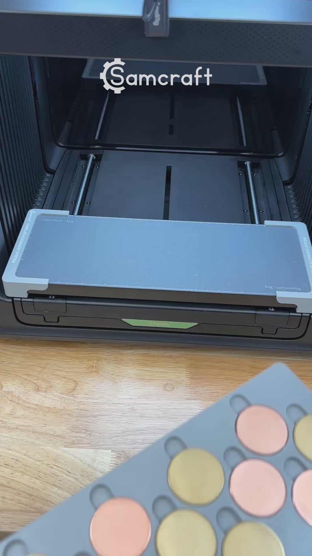 Video of the Samcraft 40mm metal coin jig for the xTool Omni UV printer being loaded with blank challenge coins and placed on the printer bed.