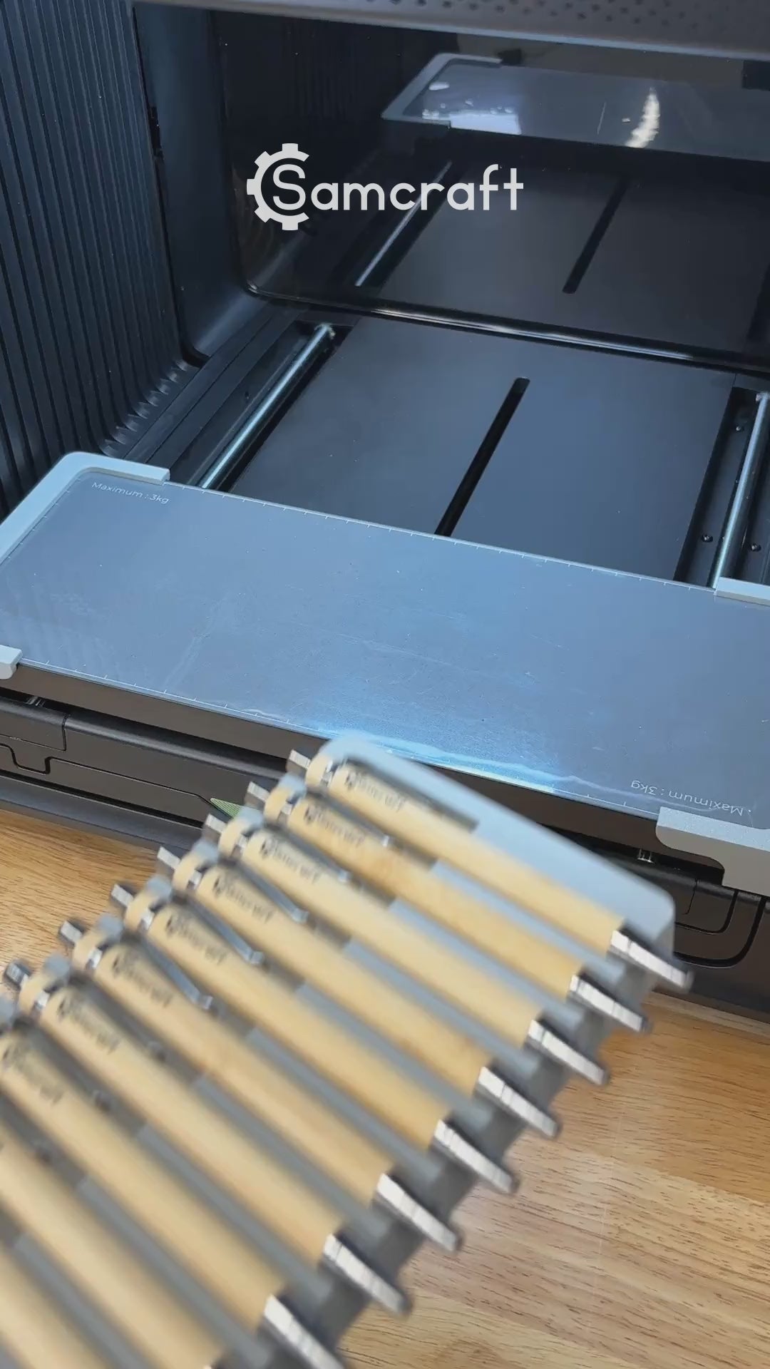 Video of the Samcraft universal 18 pen jig for the xTool Omni UV printer being loaded with bamboo pens and placed on the printer bed.
