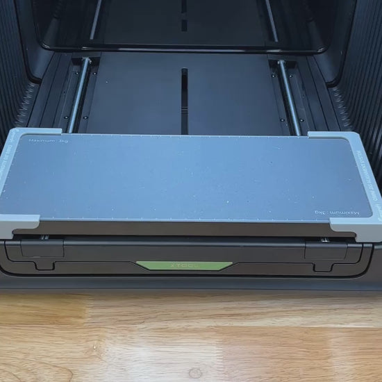 Video of the Samcraft guitar pick jig for the xTool Omni UV printer being loaded with guitar picks and placed on the printer bed.