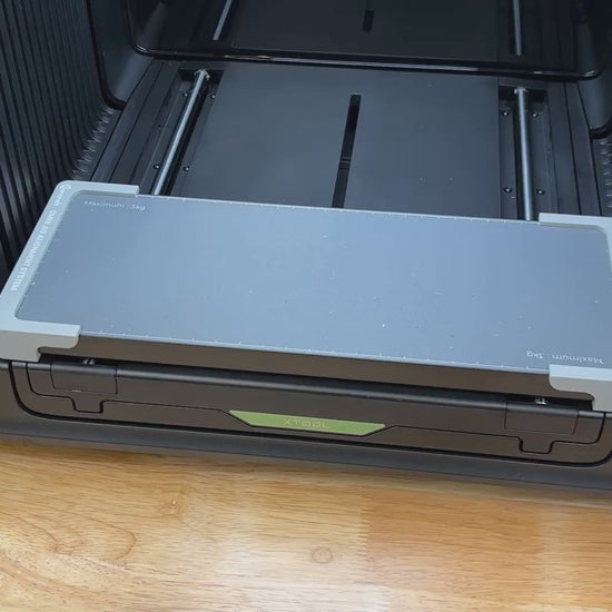 Video of the Samcraft bone pet tag jig for the xTool Omni UV printer being loaded with aluminum bone tags and placed on the printer bed.