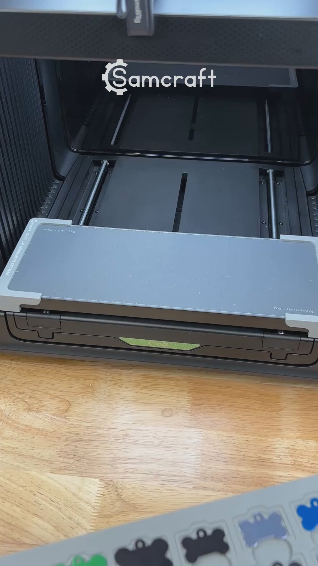 Video of the Samcraft bone pet tag jig for the xTool Omni UV printer being loaded with aluminum bone tags and placed on the printer bed.