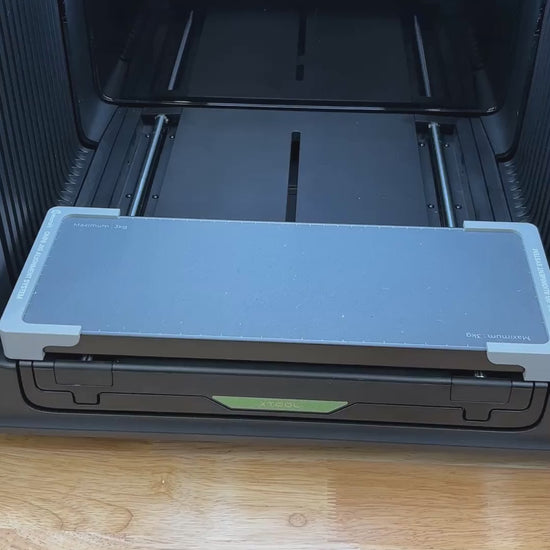 Video of the Samcraft hat brim clip jig for the xTool Omni UV printer being loaded with clips and placed on the printer bed.