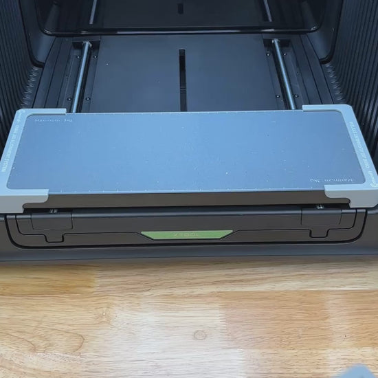 Video of the Samcraft 99mm drink coaster jig for the xTool Omni UV printer being loaded with coasters and placed on the printer bed.