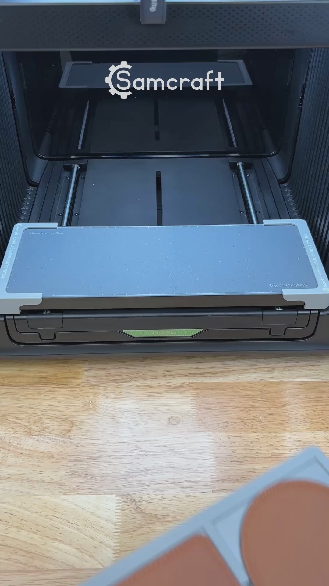 Video of the Samcraft 99mm drink coaster jig for the xTool Omni UV printer being loaded with coasters and placed on the printer bed.