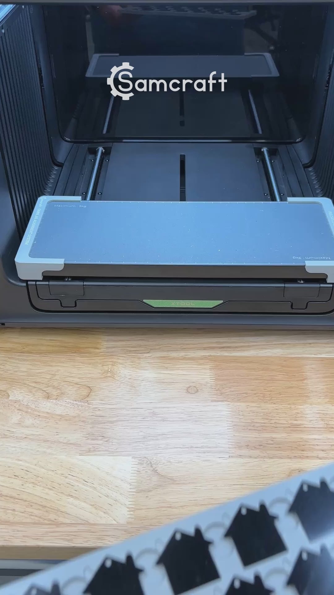 Video of the Samcraft house tag keychain jig for the xTool Omni UV printer being loaded with tags and placed on the printer bed.
