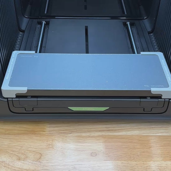 Video of the Samcraft metal luggage tag jig for the xTool Omni UV printer being loaded with tags and placed on the printer bed.