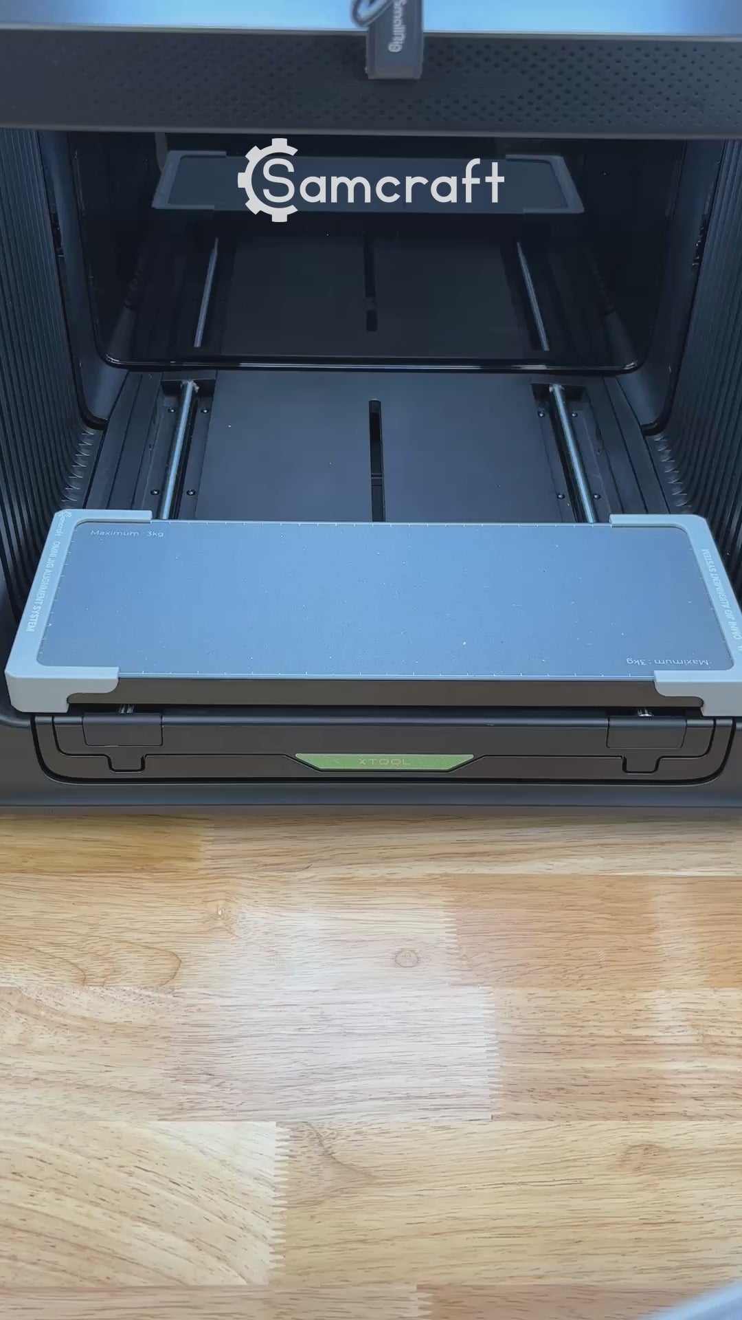 Video of the Samcraft metal luggage tag jig for the xTool Omni UV printer being loaded with tags and placed on the printer bed.