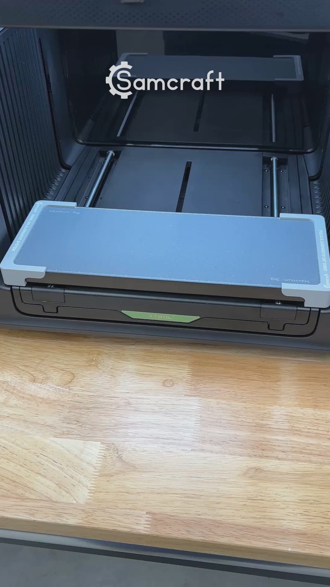 Video of the Samcraft hockey puck jig for the xTool Omni UV printer being loaded with four pucks and placed on the printer bed.