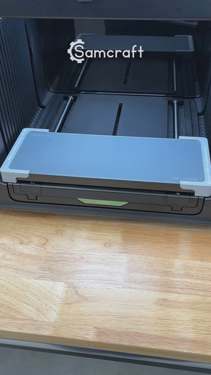 Video of the Samcraft hockey puck jig for the xTool Omni UV printer being loaded with four pucks and placed on the printer bed.