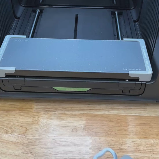 Video of the Samcraft wood handle bottle opener jig for the xTool Omni UV printer being loaded with openers and placed on the printer bed.