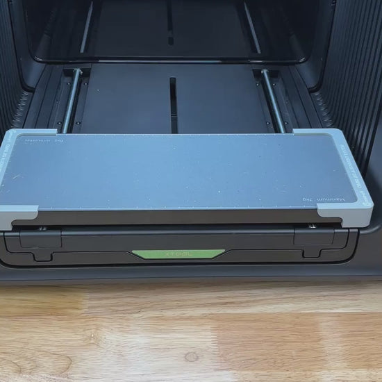 Video of the Samcraft leather key fob jig for the xTool Omni UV printer being loaded with leather fobs and placed on the printer bed.