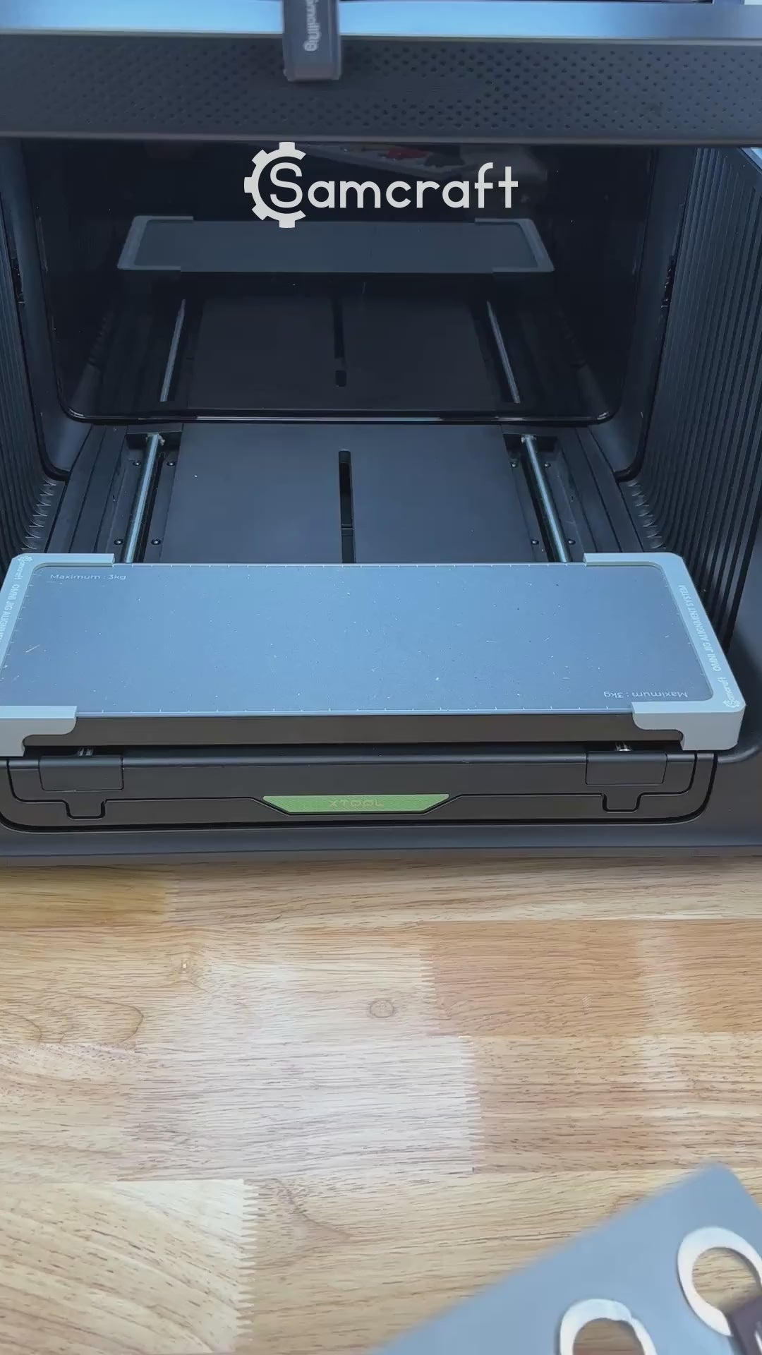 Video of the Samcraft leather key fob jig for the xTool Omni UV printer being loaded with leather fobs and placed on the printer bed.