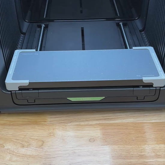 Video of the Samcraft round patch jig for the xTool Omni UV printer being loaded with leatherette patches and placed on the printer bed.