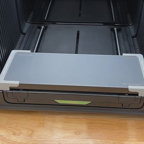Video of the Samcraft oval patch jig for the xTool Omni UV printer being loaded with leatherette patches and placed on the printer bed.