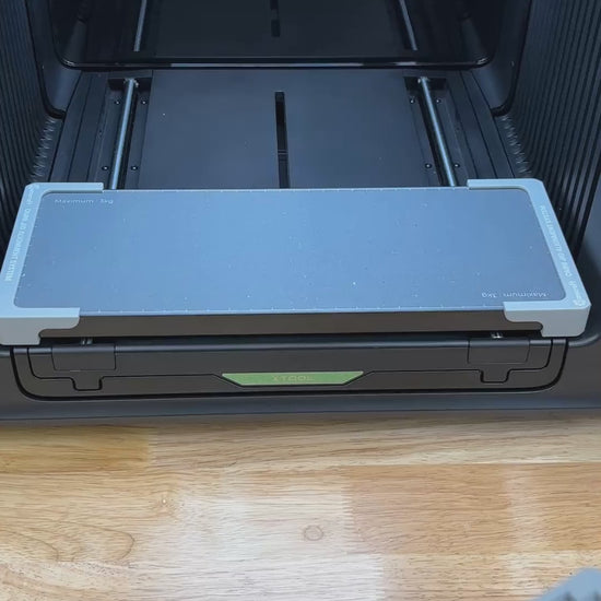 Video of the Samcraft universal 12 pen jig for the xTool Omni UV printer being loaded with pens and placed on the printer bed.