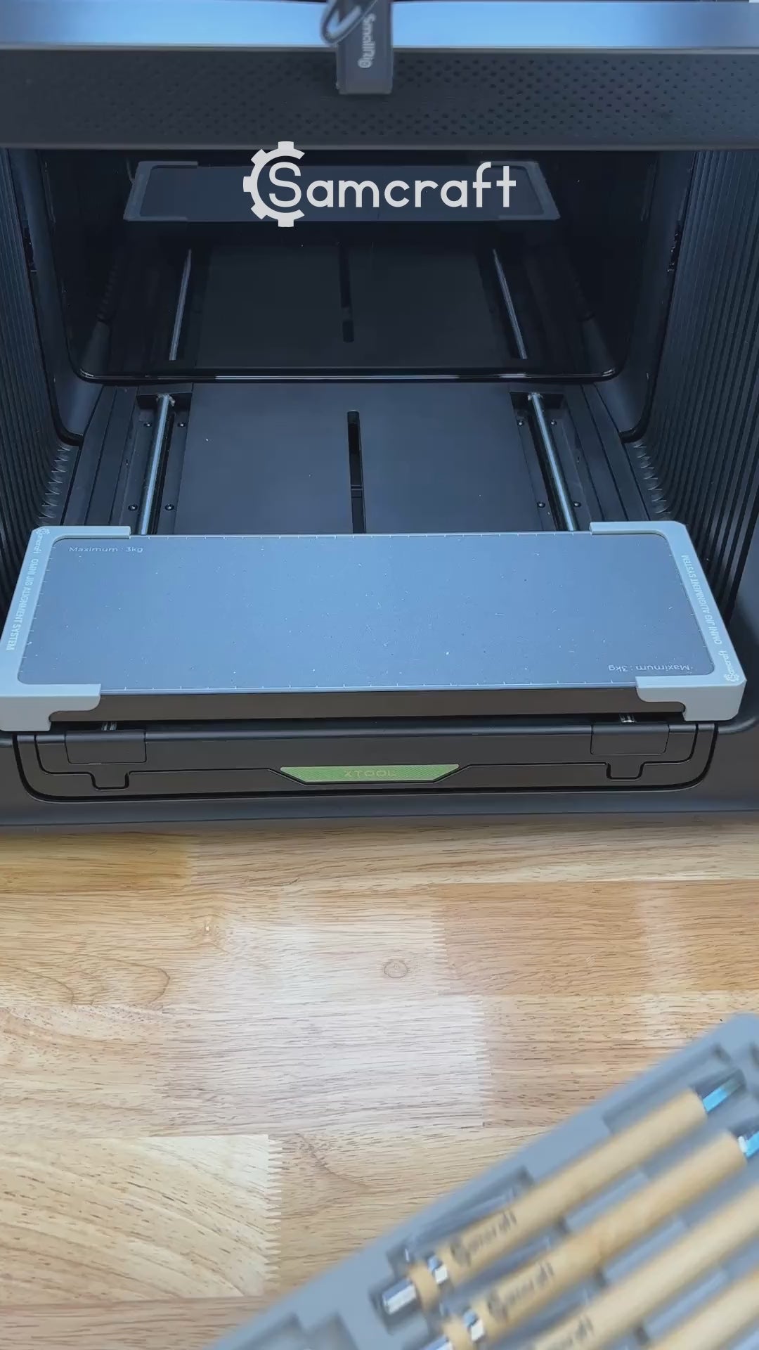 Video of the Samcraft universal 12 pen jig for the xTool Omni UV printer being loaded with pens and placed on the printer bed.