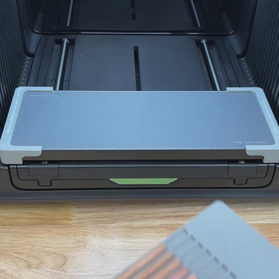 Video of the Samcraft hexagon pencil jig for the xTool Omni UV printer being loaded with pencils and placed on the printer bed.