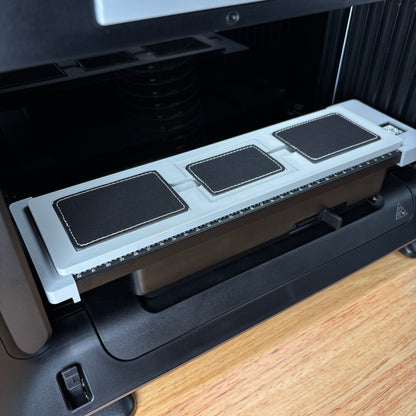 Samcraft rectangle patch jig on the eufyMake E1 print bed, holding three black rectangle patches.
