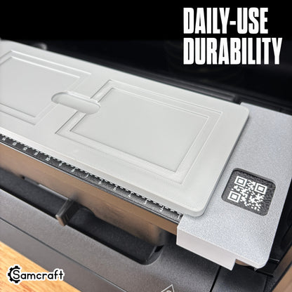 Rectangle Patch Jig for the eufyMake E1 — close-up of the empty recessed rectangular pockets in the gray 3D-printed tray with QR code and built-in alignment ruler, highlighting daily-use durability.