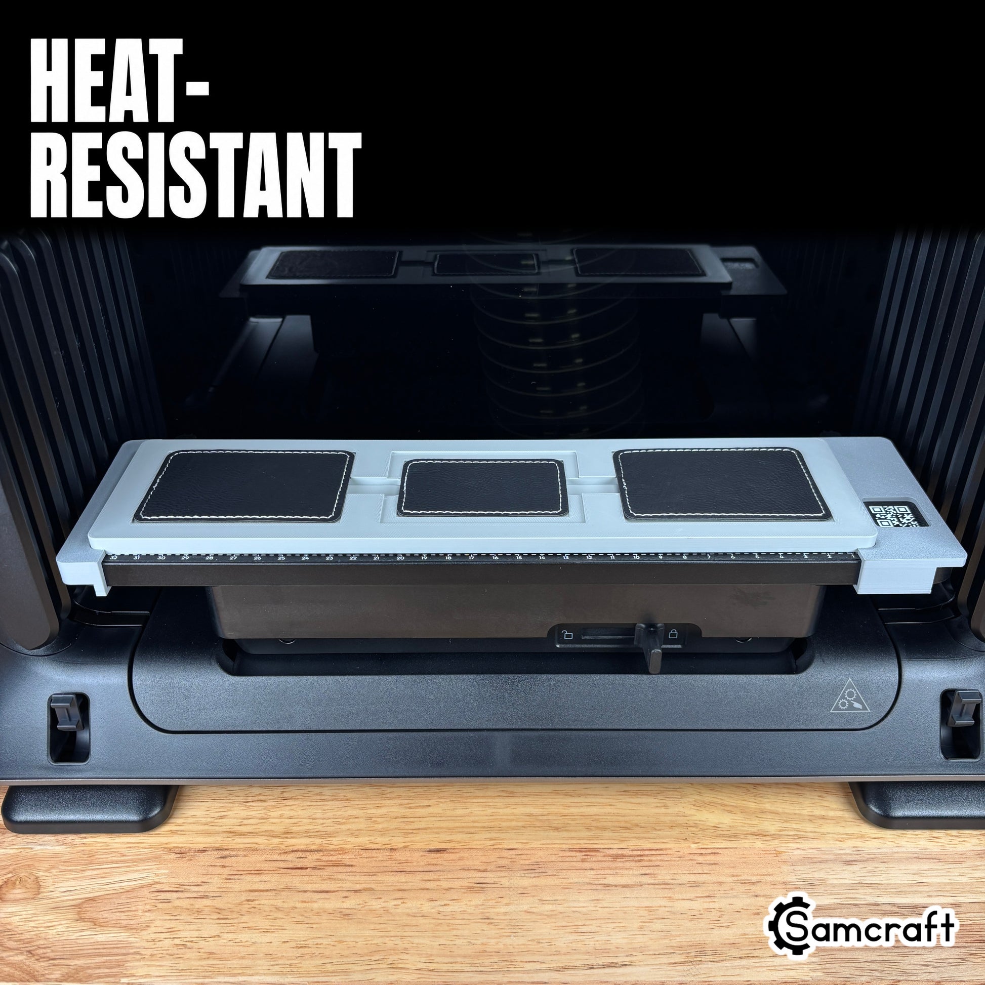 Rectangle Patch Jig for the eufyMake E1 — front view of the gray 3D-printed tray holding three black leather rectangle patches seated on the printer bed with built-in alignment ruler, highlighting the heat-resistant material.
