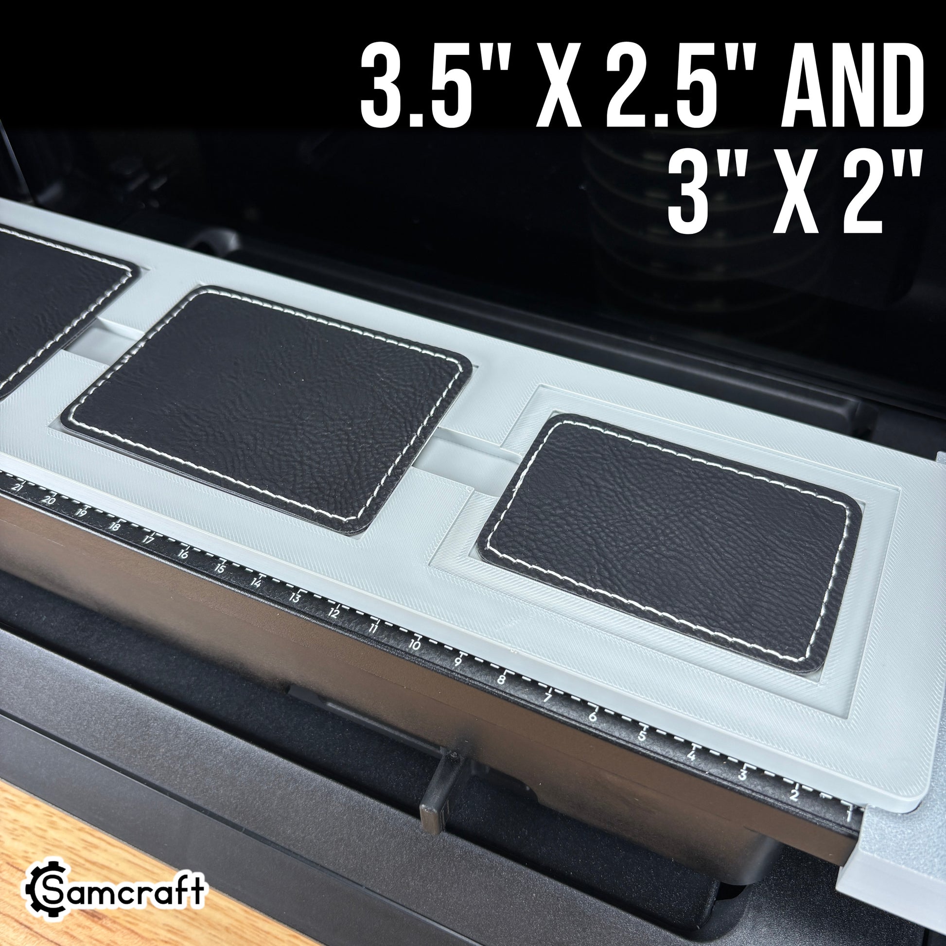 Rectangle Patch Jig for the eufyMake E1 — angled view of the gray 3D-printed tray holding black leather rectangle patches in two sizes, 3.5x2.5 inch and 3x2 inch, with built-in alignment ruler.