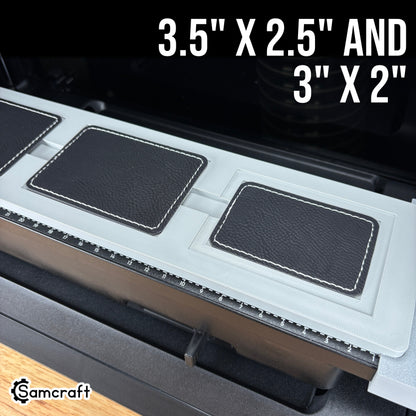 Rectangle Patch Jig for the eufyMake E1 — angled view of the gray 3D-printed tray holding black leather rectangle patches in two sizes, 3.5x2.5 inch and 3x2 inch, with built-in alignment ruler.