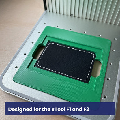 Samcraft rectangle patch jig seated in the xTool F1 base plate with a leatherette patch in the recess.