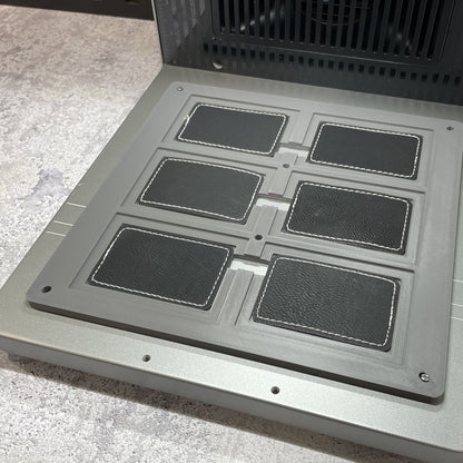 Samcraft rectangle patch jig on the xTool F2 Ultra bed, holding rectangular leatherette patches.