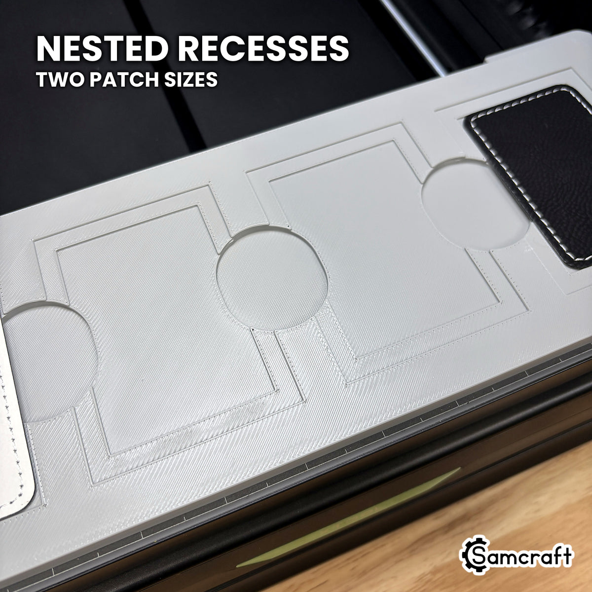 Close-up of the nested recesses in the Samcraft xTool Omni rectangle patch jig, the larger patch in the outer step and the smaller one in the inner.