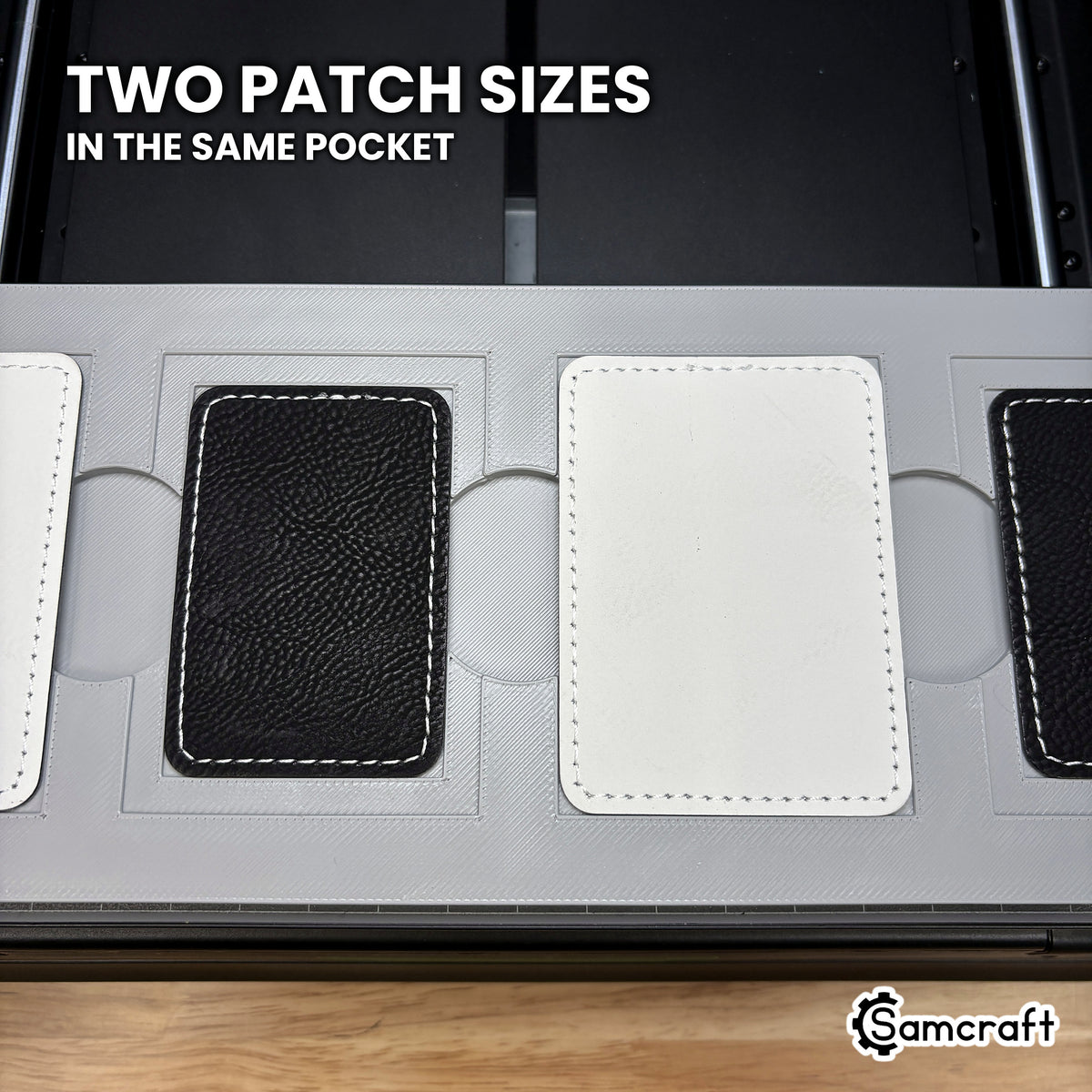 Two sizes of rectangular leatherette patch shown side by side in the Samcraft xTool Omni jig, both seated from the same nested pocket.