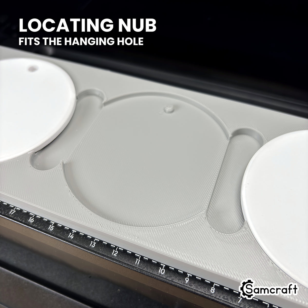 Close-up of an empty pocket in the Samcraft round ceramic ornament jig for the eufyMake E1, showing the locating nub that fits the ornament's hanging hole.