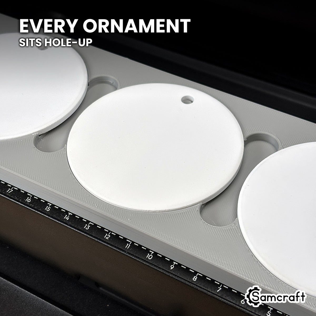 Close-up of a white round ceramic ornament seated hole-up in the Samcraft eufyMake E1 jig, next to the bed's built-in ruler.