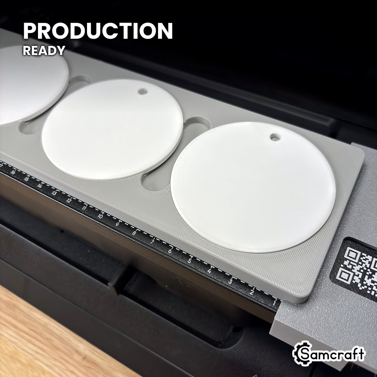 Samcraft round ceramic ornament jig holding white ceramic ornaments on the eufyMake E1 UV printer bed, set up for production runs.