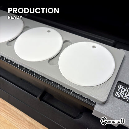 Samcraft round ceramic ornament jig holding white ceramic ornaments on the eufyMake E1 UV printer bed, set up for production runs.