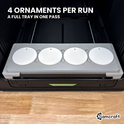 Front view of the Samcraft round ceramic ornament jig for the xTool Omni loaded with four white ceramic ornaments in a single row, a full run in one pass.